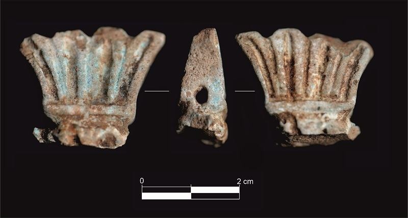 Fragment of a statuette of the deity Bes from Gorham's Cave, depicting a crown of feathers. 